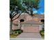 Beautiful pink two-story home boasting a tile roof, brick driveway, and lush landscaping at 8401 Riverdale Ln # 8401, Davenport, FL 33896