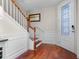 Welcoming foyer with elegant staircase, wainscoting, and decorative front door at 8401 Riverdale Ln # 8401, Davenport, FL 33896