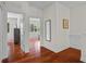 Bright hallway features gleaming hardwood floors, neutral walls, and access to other rooms in the home at 8401 Riverdale Ln # 8401, Davenport, FL 33896