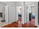 Hallway featuring hardwood floors and doorways to bathrooms and bedrooms with lots of natural light at 8401 Riverdale Ln # 8401, Davenport, FL 33896