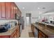 Well-equipped kitchen with stainless steel appliances, dark wood cabinetry, and granite countertops at 8401 Riverdale Ln # 8401, Davenport, FL 33896
