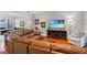 Bright living room with leather sofa and large TV at 8401 Riverdale Ln # 8401, Davenport, FL 33896