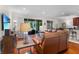Cozy living room with leather sofas, sliding glass doors, and backyard views at 8401 Riverdale Ln # 8401, Davenport, FL 33896