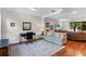 Spacious living room with hardwood floors, large window, and comfortable seating at 8401 Riverdale Ln # 8401, Davenport, FL 33896