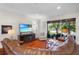 Inviting living room with hardwood floors, large windows, and comfortable furnishings at 8401 Riverdale Ln # 8401, Davenport, FL 33896