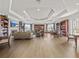 Lounge area featuring hardwood floors, a fireplace, and built-in bookshelves at 8401 Riverdale Ln # 8401, Davenport, FL 33896