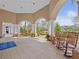 Inviting covered patio featuring comfortable rocking chairs and attractive landscaping at 8401 Riverdale Ln # 8401, Davenport, FL 33896