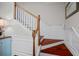 Elegant staircase with wood treads, white risers, and a decorative banister at 8401 Riverdale Ln # 8401, Davenport, FL 33896
