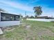 Wide view of backyard with a large patio, fence, and plentiful sunshine at 925 Roswell Ter, Deltona, FL 32738