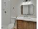 Well-lit bathroom featuring a walk-in shower and a vanity with wooden cabinets at 925 Roswell Ter, Deltona, FL 32738