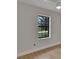 Bright bedroom featuring wood-look floors and a window providing natural light at 925 Roswell Ter, Deltona, FL 32738