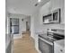 Modern kitchen featuring stainless steel appliances and sleek countertops and light colored floor at 925 Roswell Ter, Deltona, FL 32738