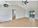 Spacious living room with high ceilings, light-colored floor, modern ceiling fan and sliding doors to backyard at 925 Roswell Ter, Deltona, FL 32738