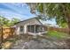 Fenced backyard with a screened-in porch, mature trees, and shade at 946 Little Creek Rd, Orlando, FL 32825