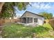 Spacious backyard featuring a screened-in porch and a privacy fence at 946 Little Creek Rd, Orlando, FL 32825