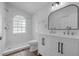 Bright bathroom with double vanity, modern fixtures, walk in shower, and neutral colors at 946 Little Creek Rd, Orlando, FL 32825