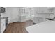 Bright kitchen featuring white cabinets, stainless steel appliances, and wood floors at 946 Little Creek Rd, Orlando, FL 32825