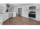Beautiful open kitchen with stainless steel appliances, white cabinets and wood floors at 946 Little Creek Rd, Orlando, FL 32825