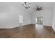 Spacious living room with ceiling fan, modern chandelier, wood floors and open floor plan at 946 Little Creek Rd, Orlando, FL 32825