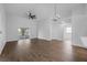 Spacious living room with fan, chandelier, wood floors, and lots of natural light at 946 Little Creek Rd, Orlando, FL 32825