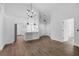 Living room with wood floors open to kitchen with white cabinets at 946 Little Creek Rd, Orlando, FL 32825