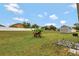Wide angle of the backyard includes a shed, lush lawn, and fencing at 954 Revere Ave, Haines City, FL 33844