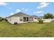 Wide angle of the backyard features a screened-in patio and lush green grass at 954 Revere Ave, Haines City, FL 33844