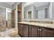 Bathroom features dual sinks, granite countertops, and a glass-enclosed shower at 954 Revere Ave, Haines City, FL 33844