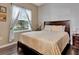 Cozy bedroom features a large window, wood floors, and a comfortable bed at 954 Revere Ave, Haines City, FL 33844