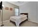 Simple bedroom with carpeted floor, a wooden bed, and natural light at 954 Revere Ave, Haines City, FL 33844