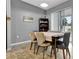 Dining area with natural light, a modern table, and a stylish china cabinet at 954 Revere Ave, Haines City, FL 33844