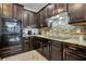 Modern kitchen features granite counters, tile backsplash, and sleek stainless steel appliances at 954 Revere Ave, Haines City, FL 33844