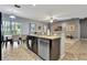 Open-concept kitchen with granite counters and modern appliances overlooking living and dining areas at 954 Revere Ave, Haines City, FL 33844