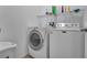 Laundry room with modern washer and dryer, plus ample storage space at 954 Revere Ave, Haines City, FL 33844
