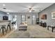Spacious living room with plush carpeting, fan, and plenty of natural light and bar seating at 954 Revere Ave, Haines City, FL 33844
