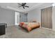 Spacious main bedroom features a tray ceiling, plush carpet, and ensuite bathroom at 954 Revere Ave, Haines City, FL 33844