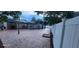 Large backyard with brick-style tiling, modern privacy fence and solar panels at 112 Rosewood Ct, Kissimmee, FL 34743