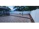 Spacious backyard featuring brick-style tiling and a modern white privacy fence at 112 Rosewood Ct, Kissimmee, FL 34743