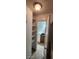 A compact bathroom with dark cabinets and shelving near the door for easy access and convenience at 112 Rosewood Ct, Kissimmee, FL 34743