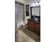 Comfortable bathroom features decorative art, a modern vessel sink, and a granite countertop vanity at 112 Rosewood Ct, Kissimmee, FL 34743