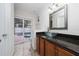 Bathroom featuring a glass bowl sink on a dark countertop, a sliding glass door at 112 Rosewood Ct, Kissimmee, FL 34743