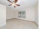 Bright bedroom featuring a ceiling fan, a large window, and tile flooring at 112 Rosewood Ct, Kissimmee, FL 34743