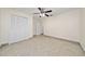 Bedroom with closet, ceiling fan, and neutral walls with tile floors at 112 Rosewood Ct, Kissimmee, FL 34743