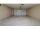 Spacious two-car garage featuring a large overhead door and a clean, painted floor at 112 Rosewood Ct, Kissimmee, FL 34743