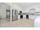 Modern kitchen with stainless steel appliances, white cabinets, and stylish backsplash at 112 Rosewood Ct, Kissimmee, FL 34743