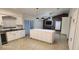 Kitchen with large island, modern appliances, and an open concept to living room at 112 Rosewood Ct, Kissimmee, FL 34743