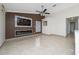 Spacious living room featuring a fireplace and large TV on a wood accent wall at 112 Rosewood Ct, Kissimmee, FL 34743