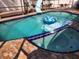 Private pool features a slide, patio seating, and a tranquil setting, perfect for outdoor enjoyment at 112 Rosewood Ct, Kissimmee, FL 34743