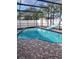 Relaxing pool with a slide, hot tub and screen enclosure is ideal for enjoying the Florida sunshine at 112 Rosewood Ct, Kissimmee, FL 34743