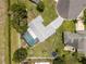 Drone view of private screened pool, fenced yard, well maintained lawn, and mature landscaping at 113 Candlewood Ct, Kissimmee, FL 34743